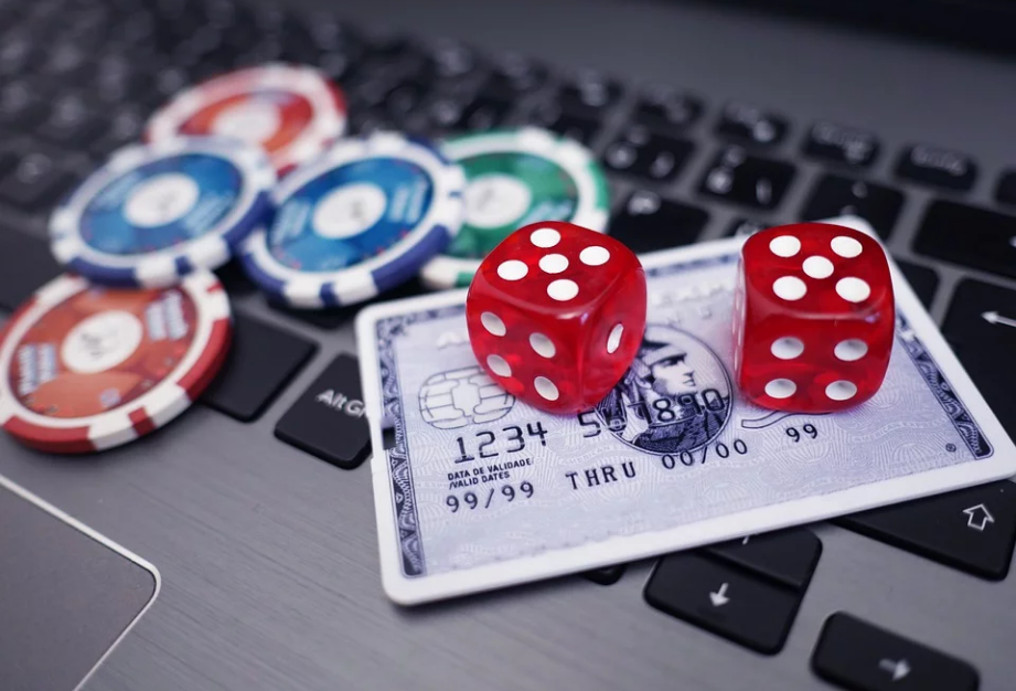 a laptop and gambling chips